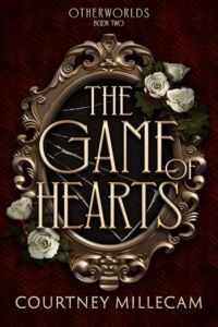 Book cover of The Game of Hearts. Has stylized letters on a gilt edge mirror with white flower clusters on hte mirror in 2 places.